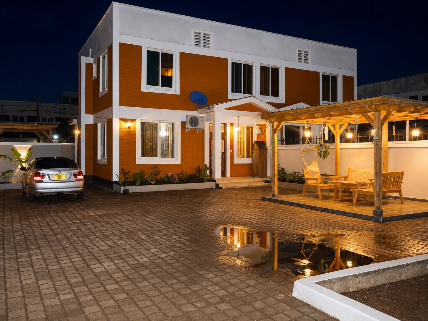 Front of the home at dusk with the pergola lit